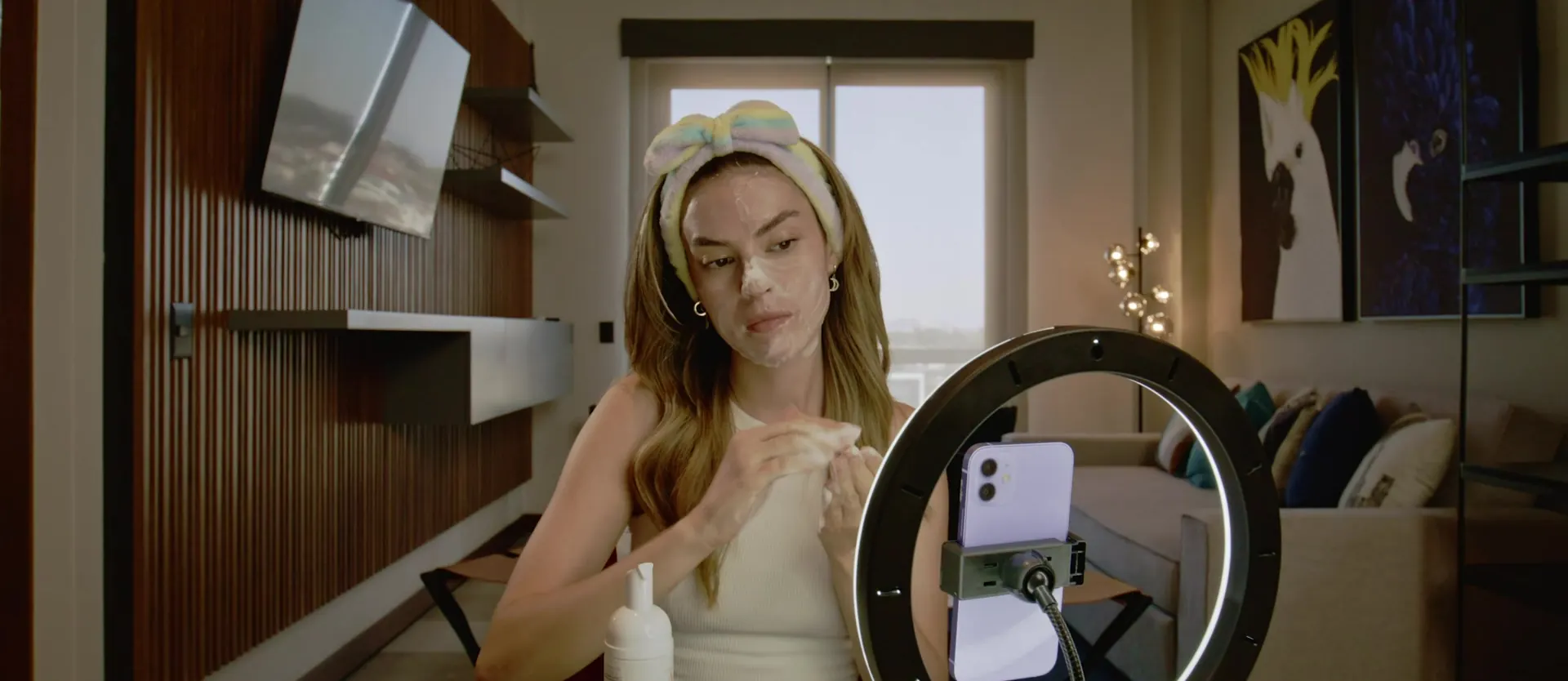 A creator recording a skincare video at home